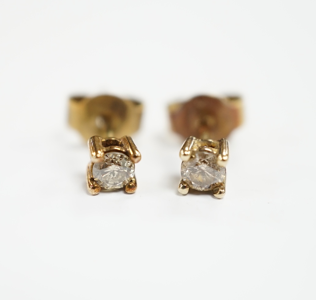 A small pair of 375 and solitaire diamond set ear studs, gross weight 0.8 grams.